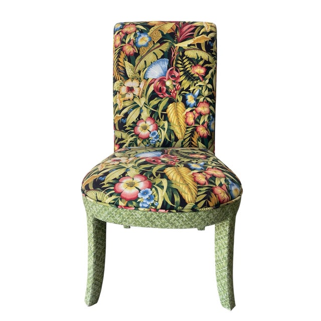 A set of four Parsons-style dining chairs upholstered in a vibrant tropical botanical fabric with contrasting green...