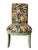 A set of four Parsons-style dining chairs upholstered in a vibrant tropical botanical fabric with contrasting green...
