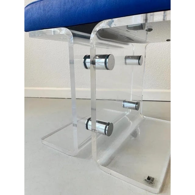 Elegant vintage stool with original blue faux leather cushion This piece has an attribution mark, I am sure that it is...