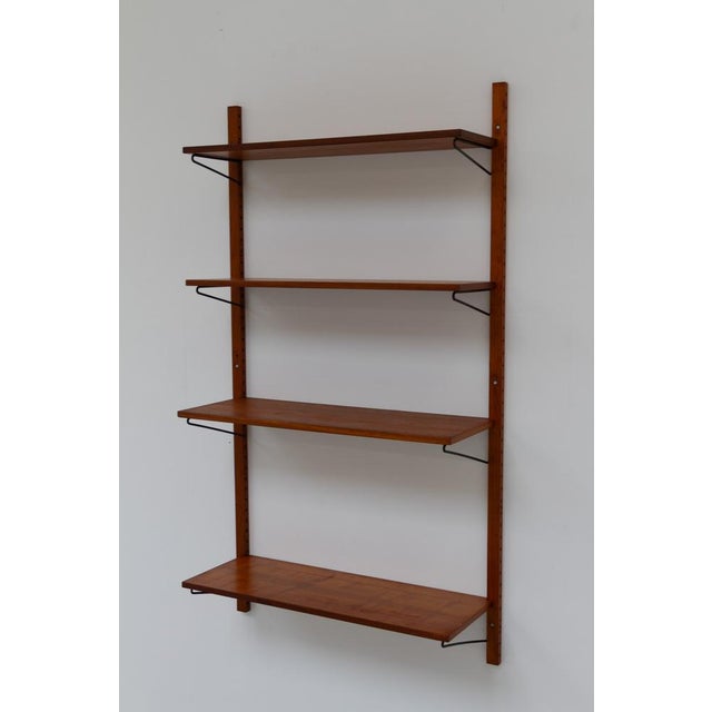 Vintage Danish wall mounted teak shelving system, 1960s. Floating Scandinavian Mid-Century Modern one bay wall unit in...