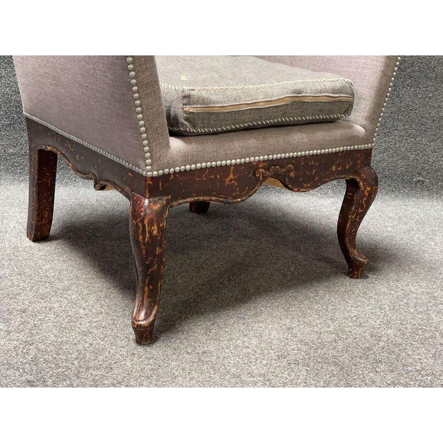 Club chair by Van Thiel and Co., featuring gray upholstered sides and seat cushion with decorative tack trim. Wooden legs...