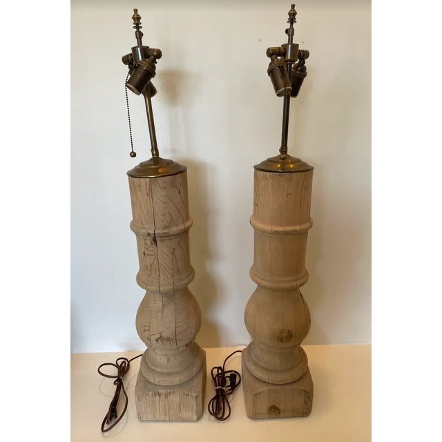 A beautiful pair of Architectural lamps of bleached pine. Large-scale and the warmth of old, smooth wood make these tall...