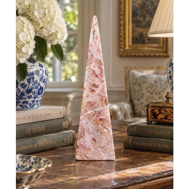A beautifully proportioned marble obelisk in richly veined shades of pink and cream. The sculptural silhouette and...