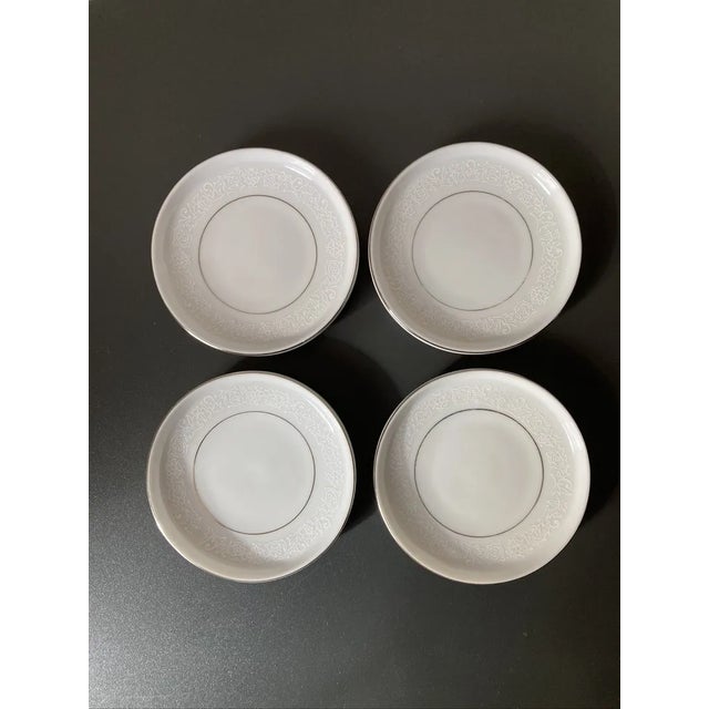 A beautiful set of four (4) white lace porcelain coasters, circa mid 20th century, Japan. Four coasters with Belle Epoque...