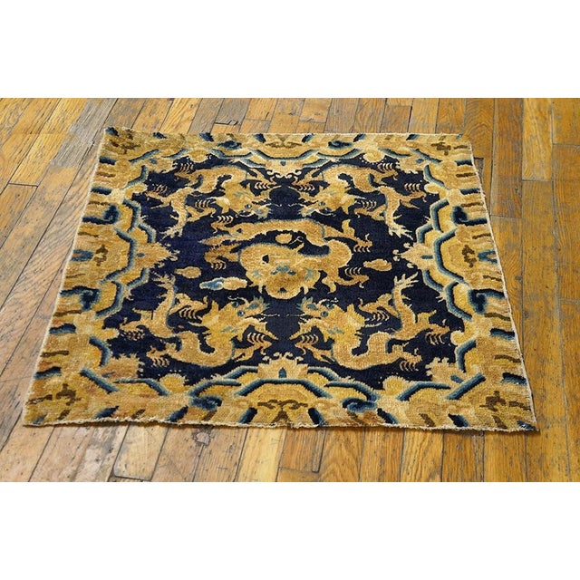 A rare dark blue chair seat with a fierce writhing central dragon and four surrounding similar creatures. Clouds are...