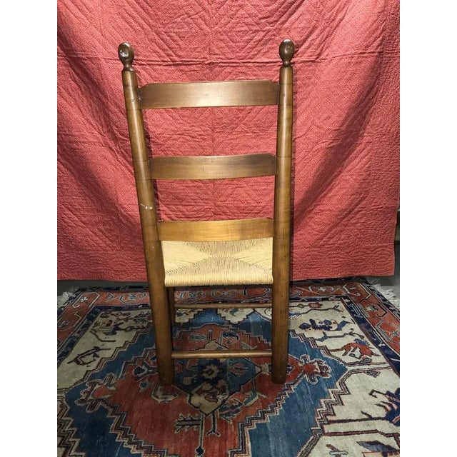This is a single Ladder back chair used decoratively. The wood is warm and in good condition, the caned seat has been...