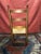 This is a single Ladder back chair used decoratively. The wood is warm and in good condition, the caned seat has been...