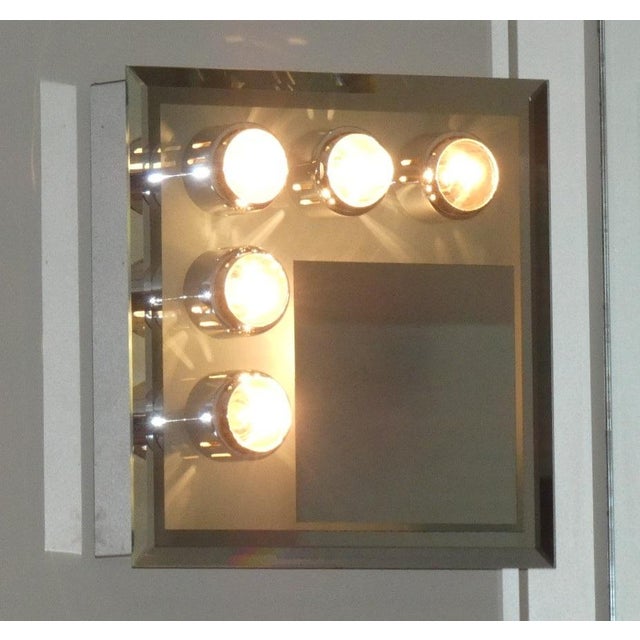 Five-spot wall light with mirror, made entirely of chrome-plated steel. the five spotlights have e14 bulb sockets,...