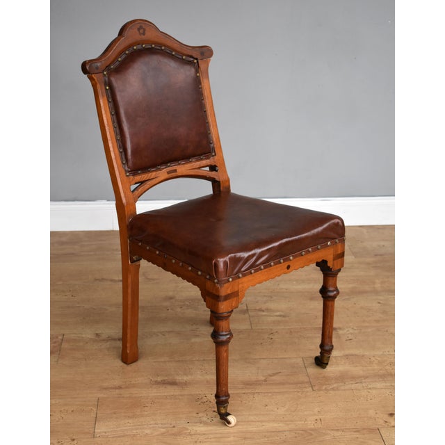For sale is a set of 6 Victorian oak dining chairs, upholstered in leather, raised on turned legs terminating on castors....