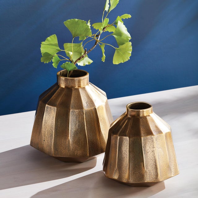 The warm metal finish and multifaceted profile makes this vase a standout piece. The depth of tone and curved lines...