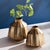 The warm metal finish and multifaceted profile makes this vase a standout piece. The depth of tone and curved lines...