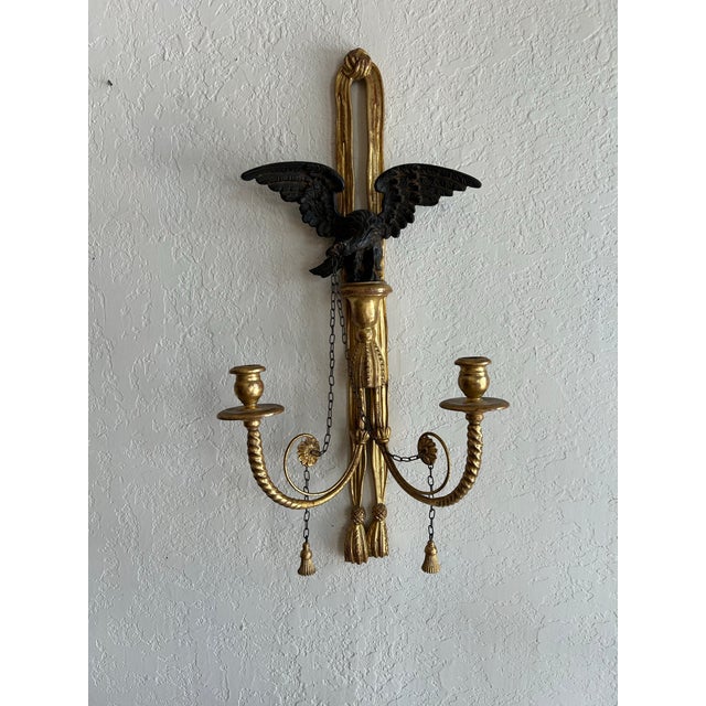 Stand out pair of Antique two light Italian parcel gilt wall sconces, handcrafted in hardwood in classical form with...