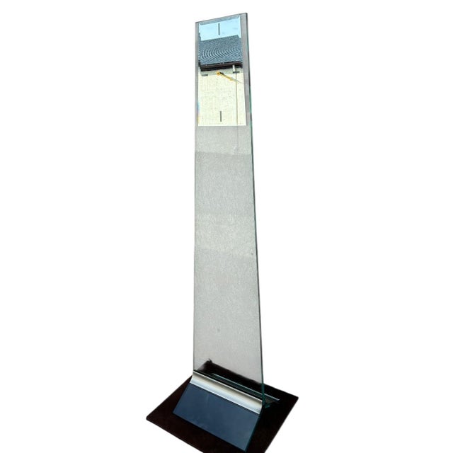 Beautiful post-modern battery-operated clock. made from thick tempered glass and metal. glass is showing reflection from...