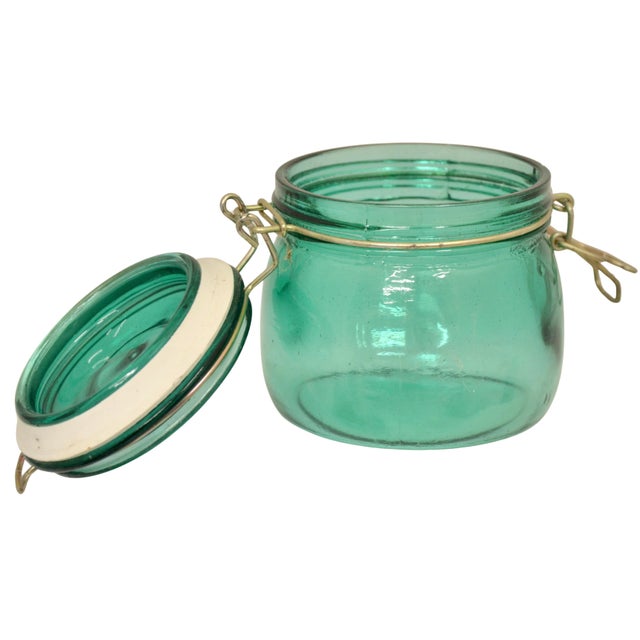 Aqua blue green teal glass vintage canister lidded jar with metal bail canister style closure. No maker's mark. Light wear.