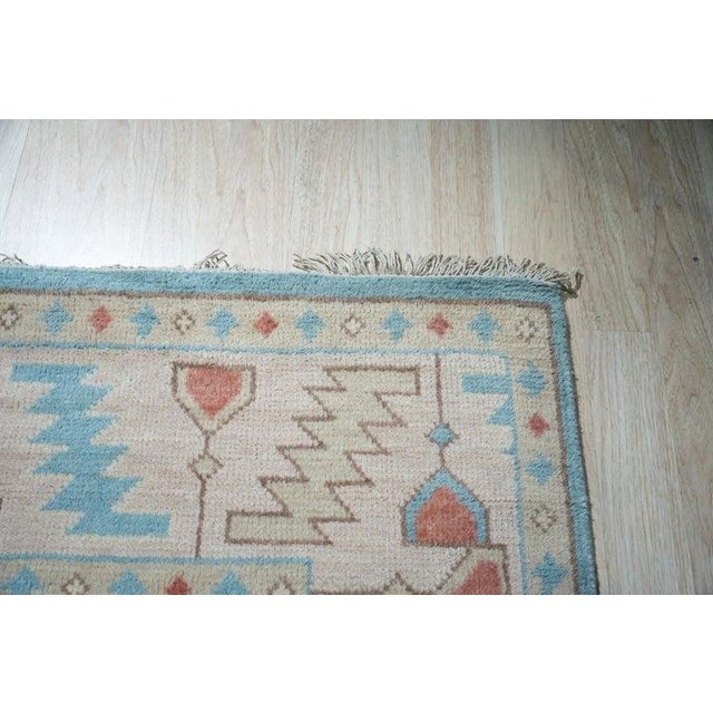 This blue wool rug features a traditional Oushak style interpreted through expert craftsmanship. Hand knotted in India,...