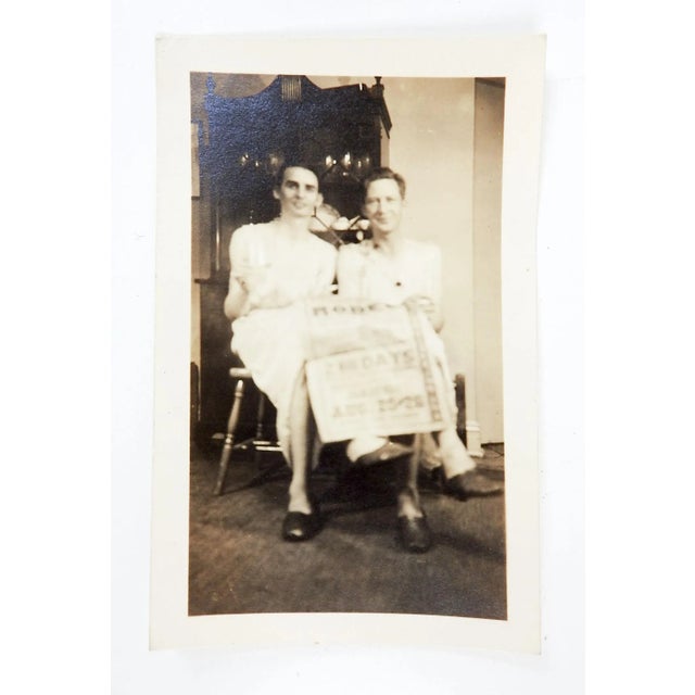 Vintage 1930's snapshot photograph of 2 men sharing a newspaper in what looks like aprons. 4.5" x 3", good condition.