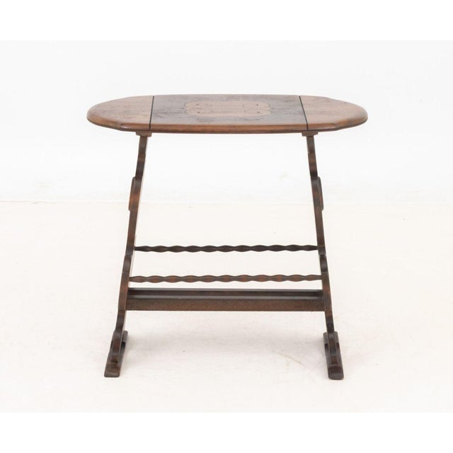 Art Deco Carved Mahogany Side Table, the top with pointillist decoration, the undertier a canterbury. 24.75" H x 26" W x...