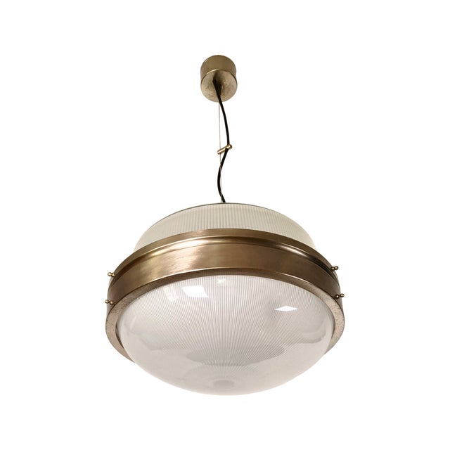 Lamp designed by sergio mazza for artemide. Thanks to its steel cable suspension, the lamp appears light and transparent,...