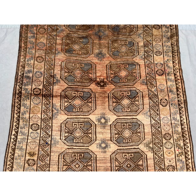 This vintage Afghan hand-knotted rug showcases a stunning example of traditional tribal artistry, blending earthy beige...