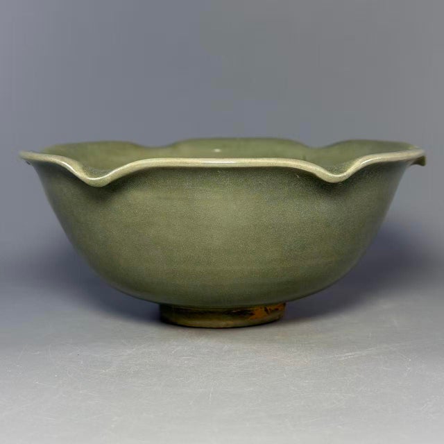 Beautiful antique Chinese Longquan celadon bowl with floral‑shaped rim. Delicate hand‑carved pattern on interior, smooth...