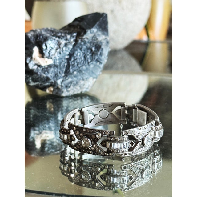 1920s Art Deco 935 silver panel bracelet featuring repeating rectangular links with geometric milgrain borders, circular...