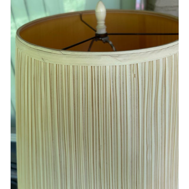 Vintage table lamp with matching shade and finial. Lamp is made of ceramic, cluster of faux bamboo with green leaves....