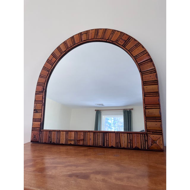 This is a beautiful arched/half-moon (demilune) mirror with a distinctly rustic, bohemian, or coastal style. Warm honey...