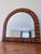 This is a beautiful arched/half-moon (demilune) mirror with a distinctly rustic, bohemian, or coastal style. Warm honey...
