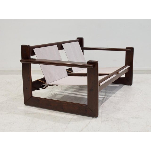 Mid-20th century sofa with veneered walnut wood frame and beige canvas fabric seats. Made in Brazil circa 1960s. The frame...