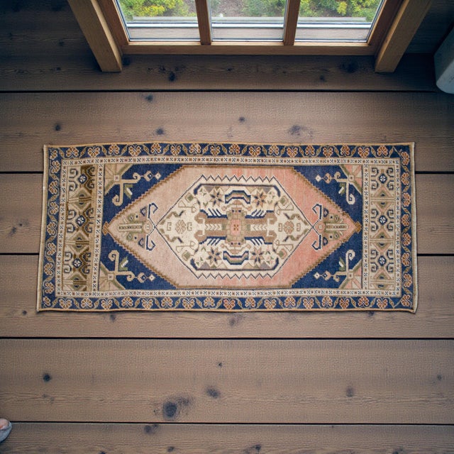 Vintage Turkish hand-knotted small rug from Oushak (Aegean), 1970s, featuring warm blush-and-sand tones and authentic...