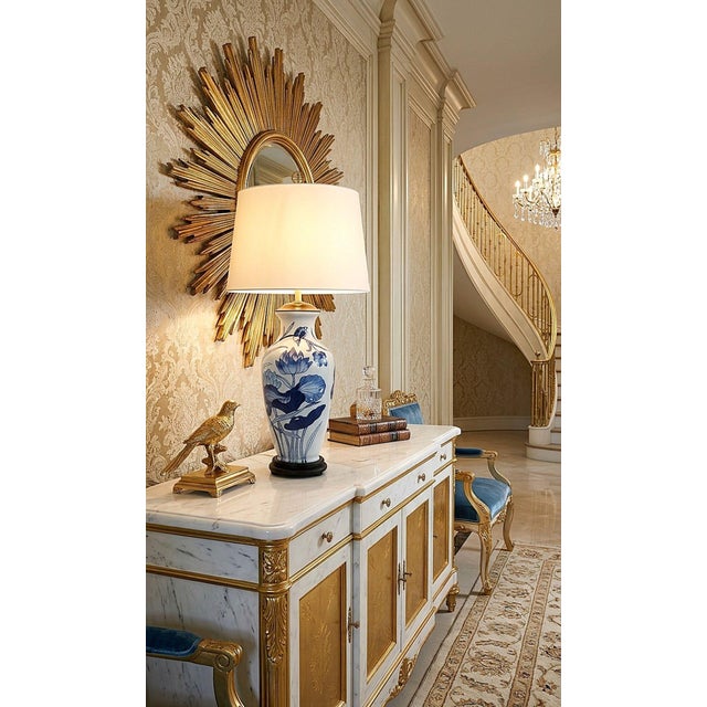 Offering a RESTORED vintage blue and white Chinese porcelain table lamp depicting lotus flowers and birds, circa 1970s....