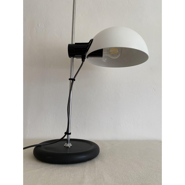The metal base has been professionally powder-coated in matte black. The original white shade has been carefully cleaned...