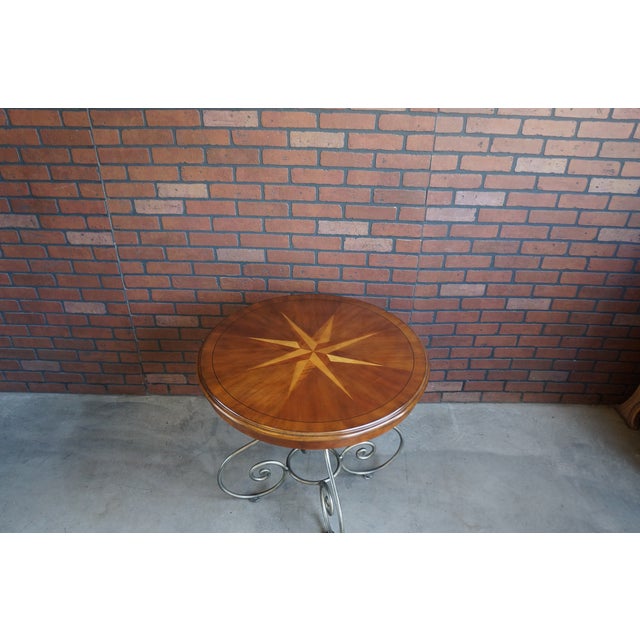 Maison by Ethan Allen round inlayed top iron base end table. Versatile styling makes this end table suitable to any decor....