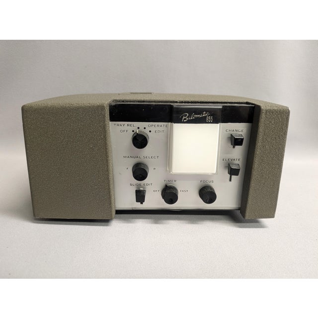 A classic Bausch & Lomb Balomatic 655 slide projector in taupe gray. The vintage slide projector is in working order,...