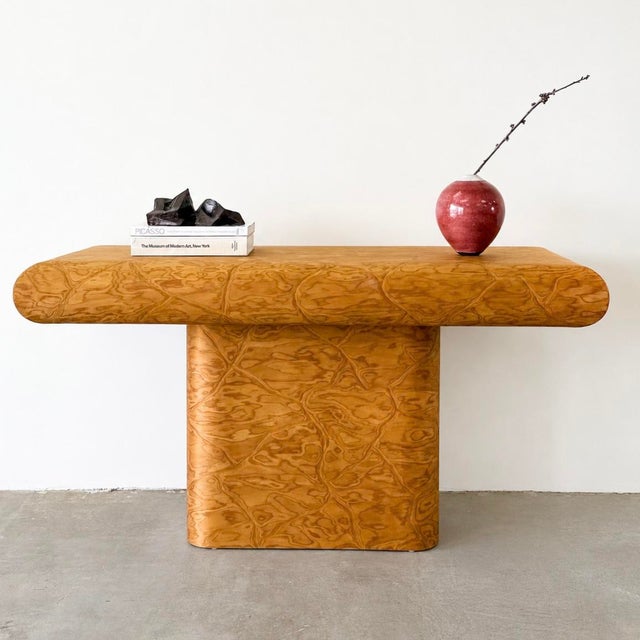 Vintage 1980s Postmodern bullnose console table featuring a warm caramel-toned veneer with richly figured movement...