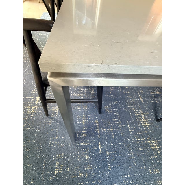 Room and Board Rand Dining Room Table A floating taupe quartz sits a top a durable steel base with sleek corner-set legs...