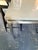 Room and Board Rand Dining Room Table A floating taupe quartz sits a top a durable steel base with sleek corner-set legs...