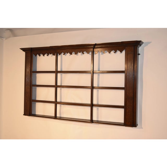 Late 18th century Georgian oak wall shelf with stepped crown molding which has dental detail as well, following down to a...