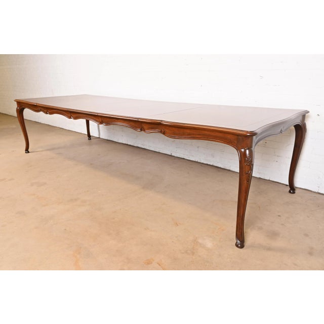 An exceptional French Provincial Louis XV style extension dining table By Baker Furniture USA, Circa 1960s Beautiful...