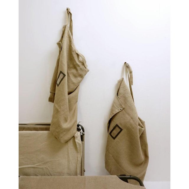 French Army Camp Beds, 1970s Wear consistent with age and use.Measures : 207cmx70cm H:43cm Materials : Fabic - Metal