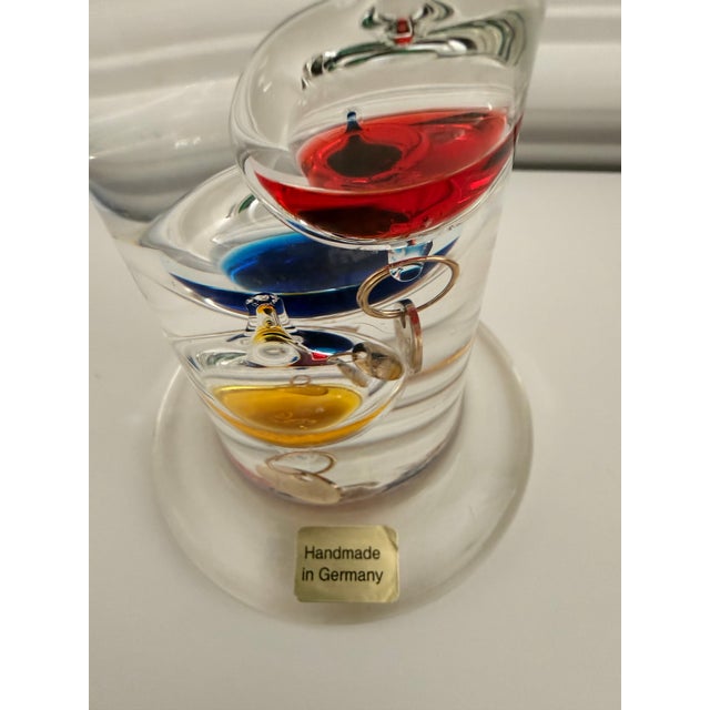 Beautiful handmade German Galileo thermometer featuring hand-blown glass construction with colorful floating glass bulbs...