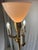 This Stiffel 4-Light Torchiere is a brass floor lamp with a milk glass shade. The central milk glass lamp operates on an...