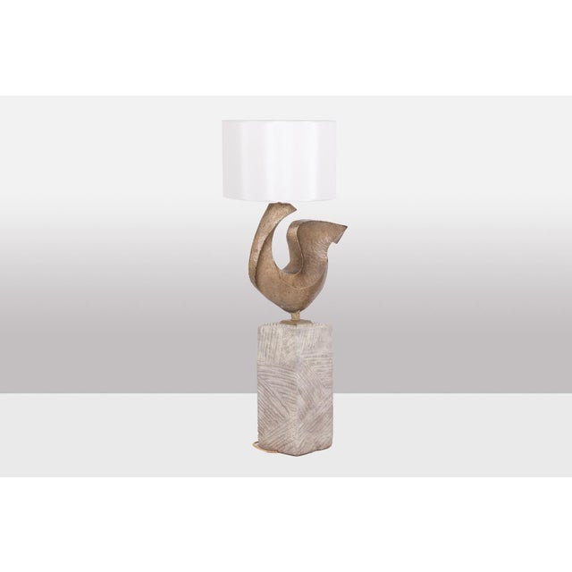 Lamps suggesting stylized bird, resting on a rectangular grooved stone base. French work realized in the 1970s. This piece...