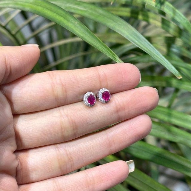 Contemporary 18k White Gold Natural Oval-Cut Vivid Red Ruby & Diamond Halo Stud Earrings- A Pair For Sale - Image 3 of 15