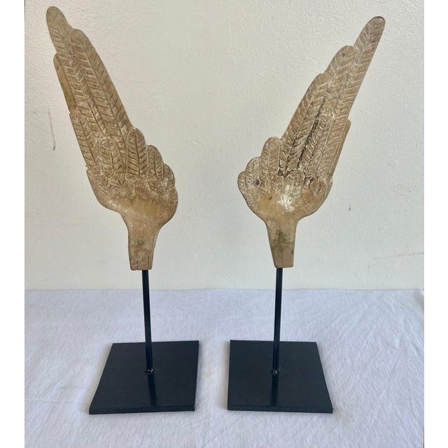 Pair of hand carved wood Italian wings that are newly mounted on iron bases. Great display items for your bookcase.