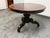 Design Plus Gallery presents an Antique Victorian Mahogany Loo Table. It has a round tilt top design, glossy brown...