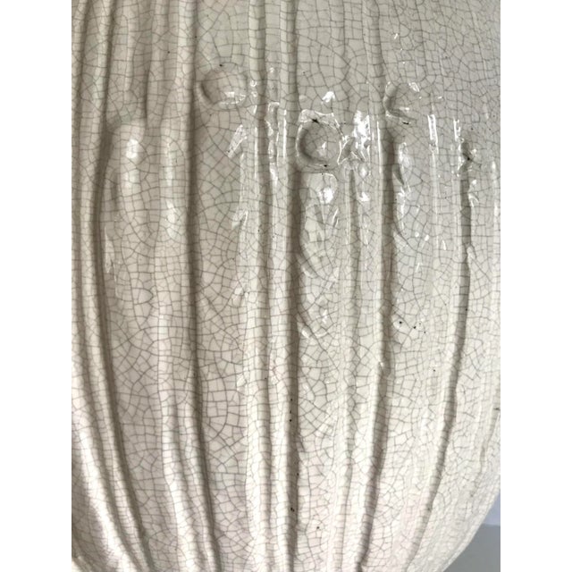 Here is a stunning and impressively sized lamp from the mid-century that is accentuated with a beautiful crackle glaze in...