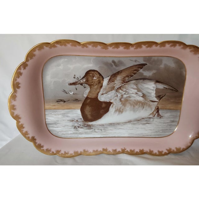 An Antique French Limoges Platter. The Platter is made of porcelain and has a hand painted design of a Duck or Goose. It...