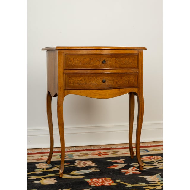 French Louis XV style walnut nightstand, 20th century, having serpentine top, above two drawers with burl wood fronts,...
