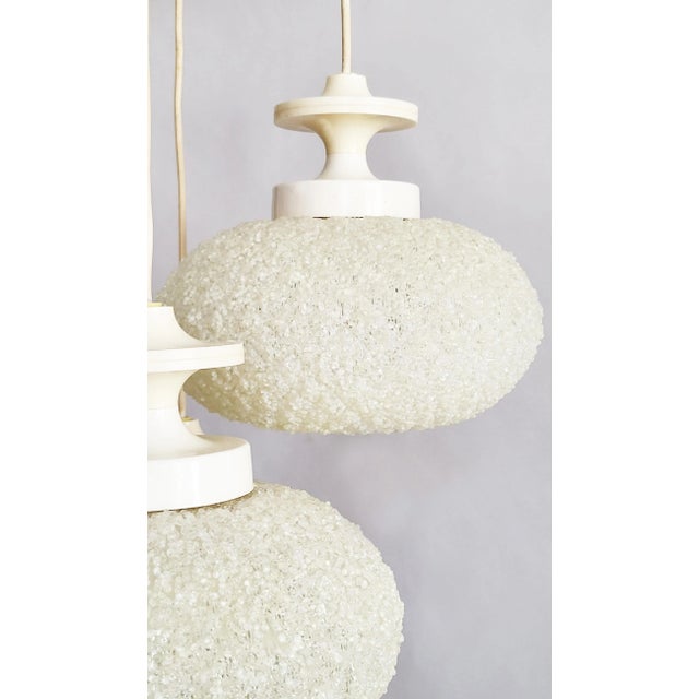 A classic, glamorous retro-futurist Space Age design from the 1960s: five cascading moon-like spheres that give off a...